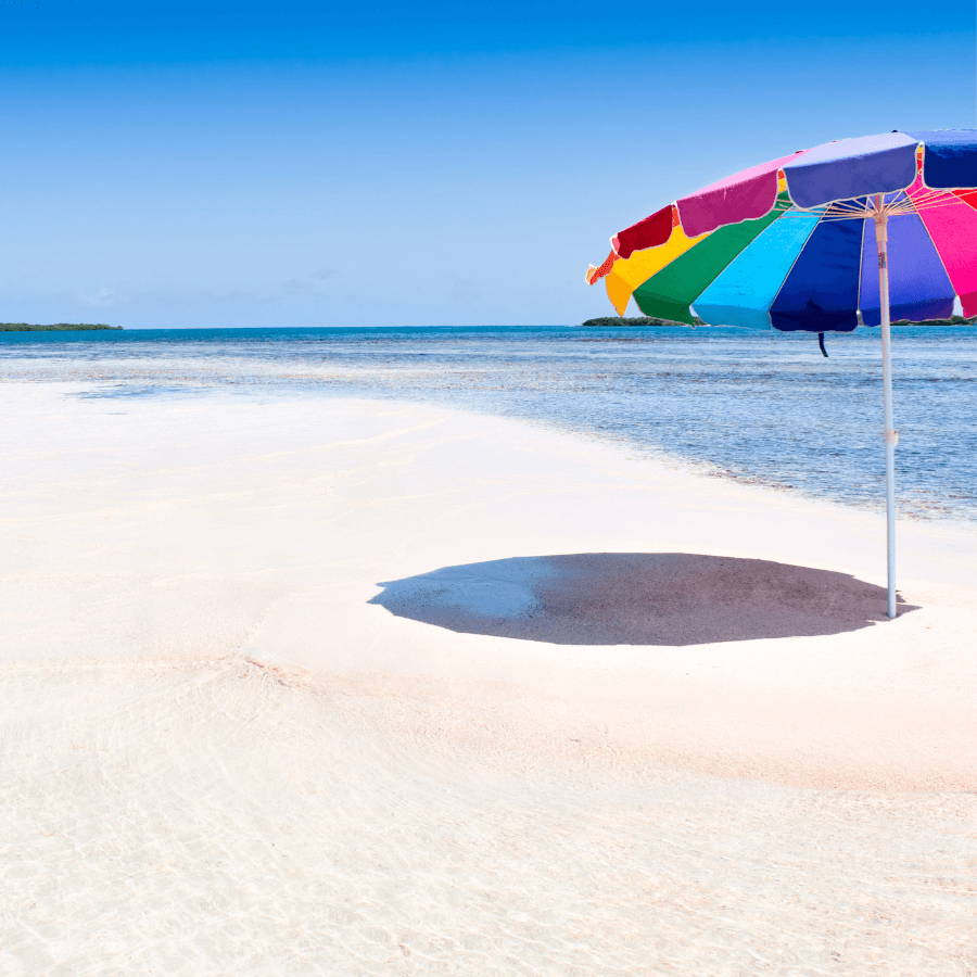 Multicolor umbrella on beach near the ocean